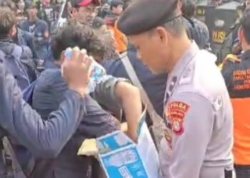 Polisi Bagikan Air Mineral kepada Massa Demo di Senayan