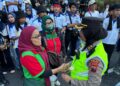 Polwan Negosiator Polda Jateng Bagikan Bunga Sebagai Wujud Empati Perjuangan Buruh Selama Aksi May Day di Kantor Gubernur Jateng