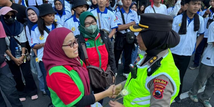 Polwan Negosiator Polda Jateng Bagikan Bunga Sebagai Wujud Empati Perjuangan Buruh Selama Aksi May Day di Kantor Gubernur Jateng