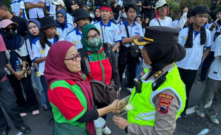 Polwan Negosiator Polda Jateng Bagikan Bunga Sebagai Wujud Empati Perjuangan Buruh Selama Aksi May Day di Kantor Gubernur Jateng